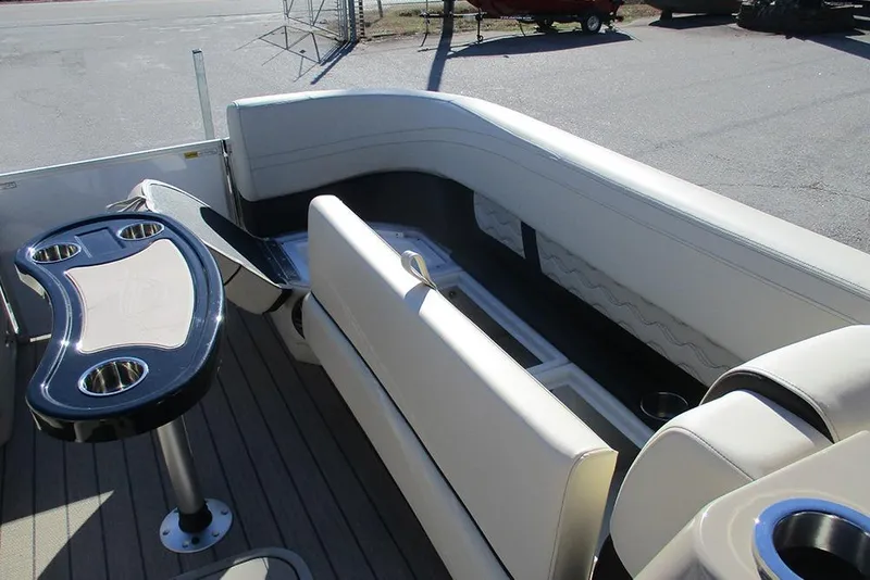 Slide: The Image of 2026 SunCatcher Fusion 324RC boat interior with seating and table, showcasing luxury design. - 11