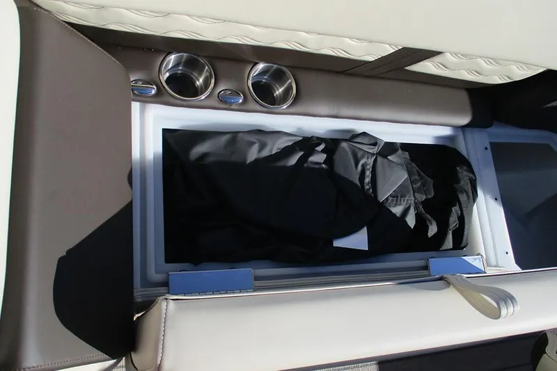 Slide: The Image of Storage compartment with cup holders in 2026 SunCatcher Fusion 324RC boat. - 16