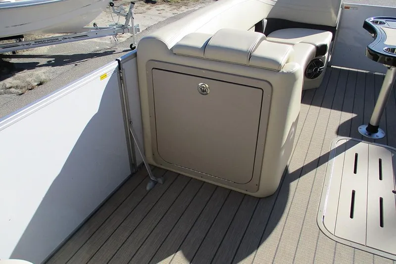 Slide: The Image of 2026 SunCatcher Fusion 324RC boat interior with beige seating and storage compartment. - 18