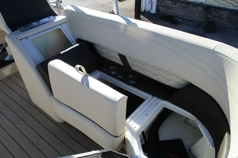 Slide: The Image of 2026 SunCatcher Fusion 324RC boat interior with beige seating and storage compartments. - 26