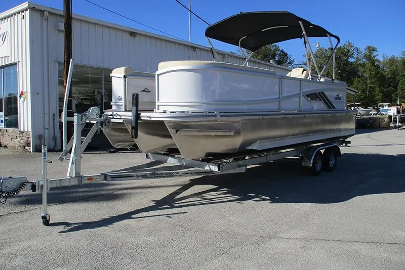 Slide: The Image of 2026 SunCatcher Fusion 324RC pontoon boat on trailer, parked outdoors. - 3