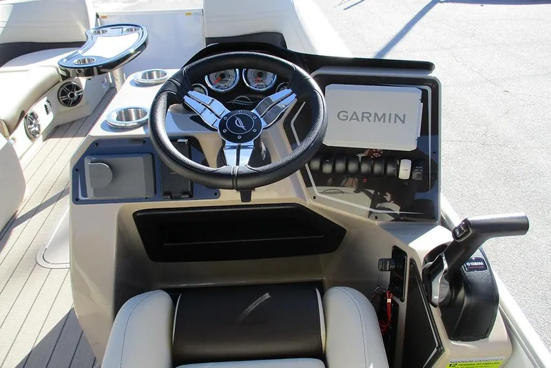 Slide: The Image of 2026 SunCatcher Fusion 324RC boat dashboard with Garmin navigation system and steering wheel. - 33
