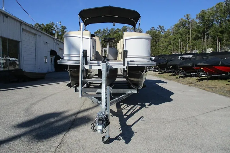 Slide: The Image of 2026 SunCatcher Fusion 324RC pontoon boat on trailer, parked outdoors. - 4