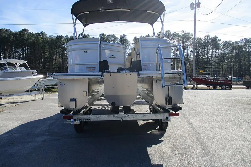 Slide: The Image of 2026 SunCatcher Fusion 324RC pontoon boat on trailer, parked outdoors. - 8