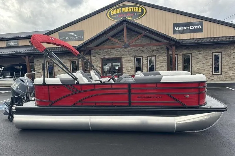 Slide: The Image of 2026 Bennington 20 S Quad Bench pontoon boat displayed at dealership. - 2