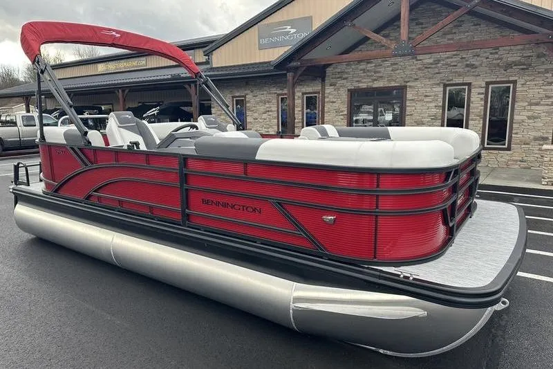 Slide: The Image of 2026 Bennington 20 S Quad Bench pontoon boat with red exterior, parked outside dealership. - 8