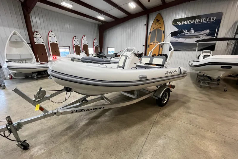 The Image of 2026 Highfield Classic 420 boat displayed in showroom on trailer. - 1