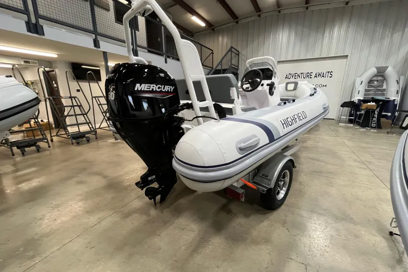 Slide: The Image of 2026 Highfield Classic 420 boat with Mercury engine in showroom. - 12
