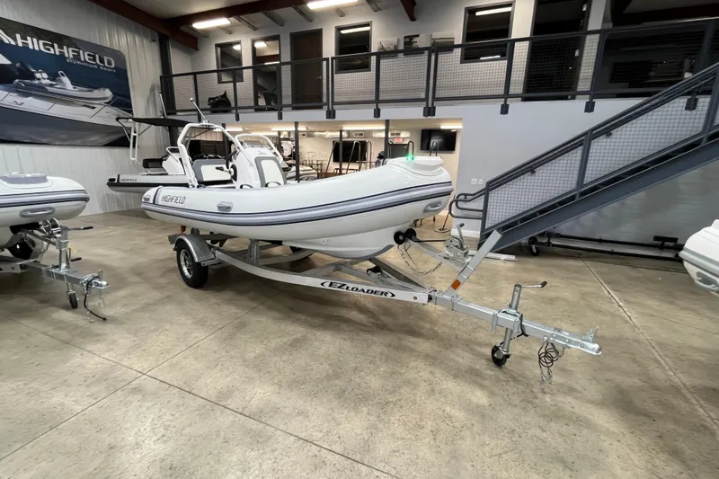 Slide: The Image of 2026 Highfield Classic 420 boat on trailer in showroom setting. - 3