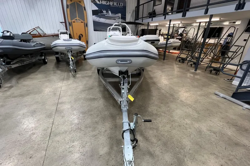 Slide: The Image of 2026 Highfield Classic 420 boat displayed in a showroom on a trailer. - 4