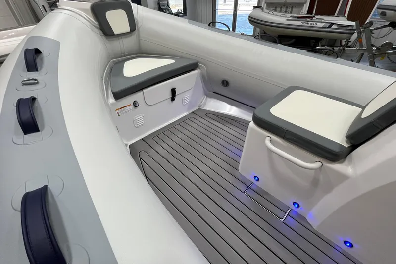 Slide: The Image of 2026 Highfield Classic 420 boat interior with cushioned seating and modern design. - 7