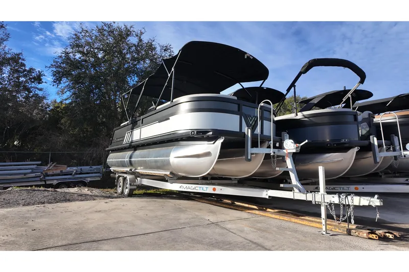 Slide: The Image of 2026 Viaggio Diamante D22U pontoon boat on trailer, parked outdoors. - 2