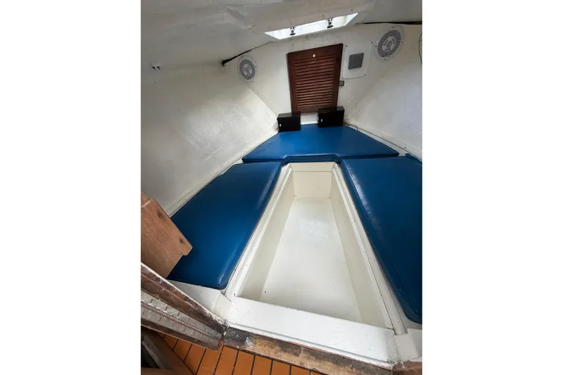 Slide: The Image of 1967 Formula 233 boat interior with blue cushions and wooden accents. - 11