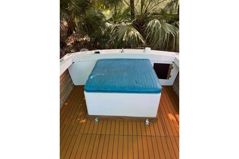 Slide: The Image of 1967 Formula 233 boat interior with blue cushioned seat and wooden deck. - 8