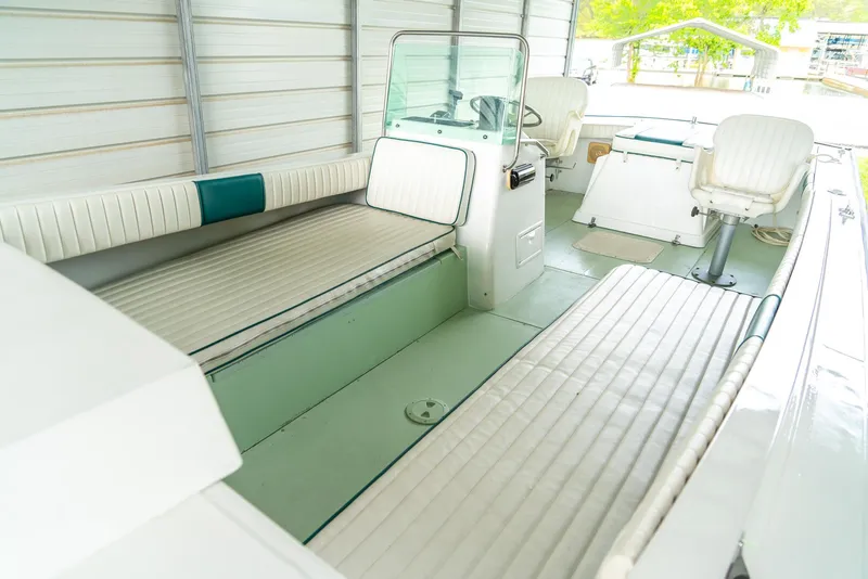 Slide: The Image of 1976 Aquasport 24 Launch boat interior with white seating and steering console. - 11