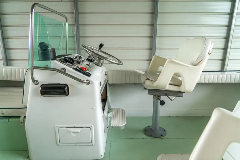 Slide: The Image of 1976 Aquasport 24 Launch boat interior with steering console and captain's chair. - 14