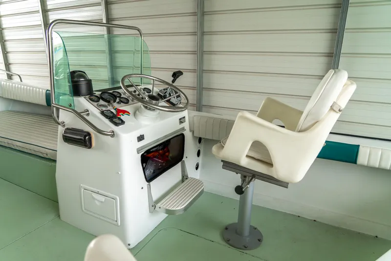 Slide: The Image of 1976 Aquasport 24 Launch boat helm with steering wheel and captain's chair. - 16