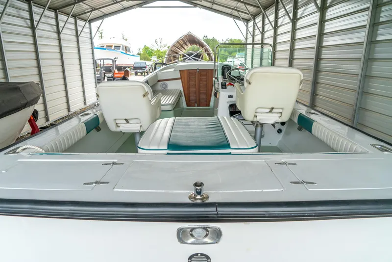 Slide: The Image of 1976 Aquasport 24 Launch boat interior with white seating under a metal canopy. - 17
