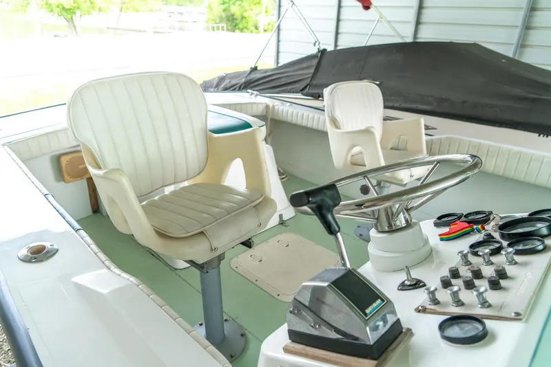 Slide: The Image of 1976 Aquasport 24 Launch boat interior with steering wheel and control panel. - 20