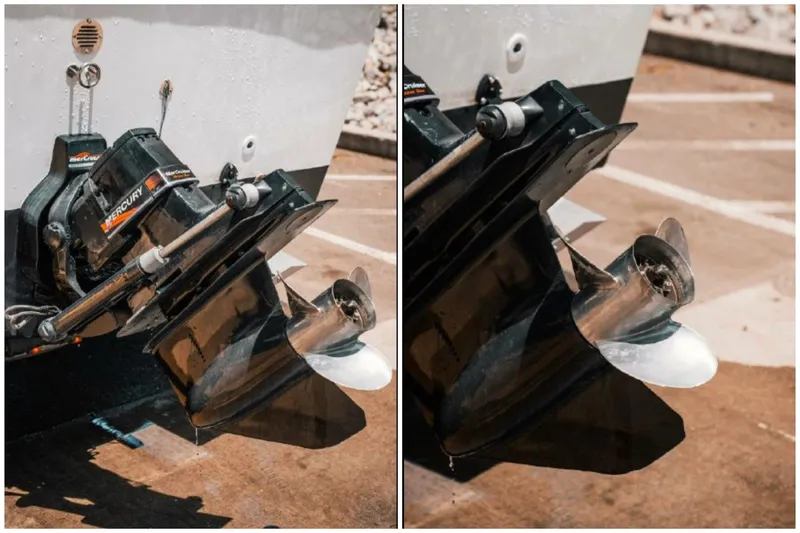 Slide: The Image of 1976 Aquasport 24 Launch boat propeller and outboard motor close-up. - 24