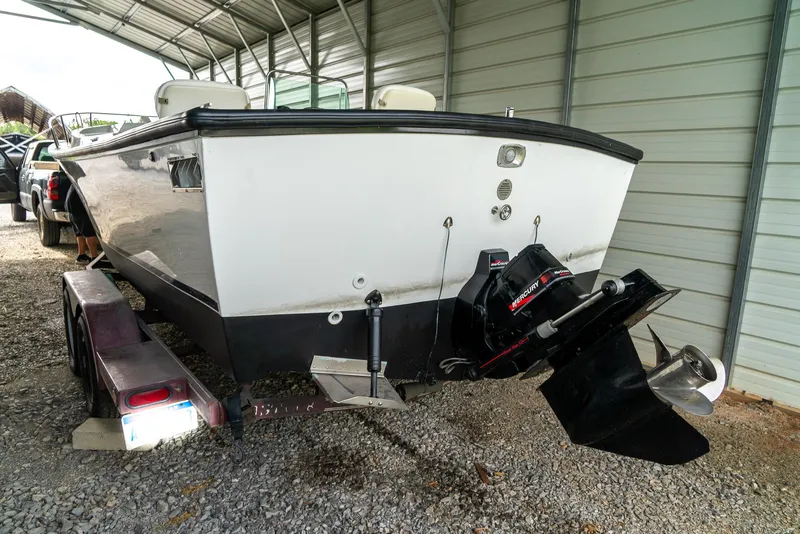 Slide: The Image of 1976 Aquasport 24 Launch boat on trailer in covered storage area. - 7