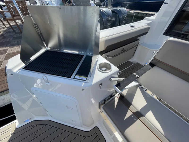 Slide: The Image of 2023 Cutwater C-288 boat with built-in grill and seating area. - 15