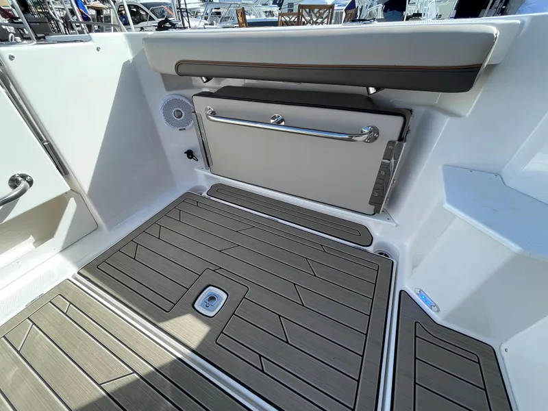 Slide: The Image of 2023 Cutwater C-288 boat interior with teak flooring and storage compartment. - 18