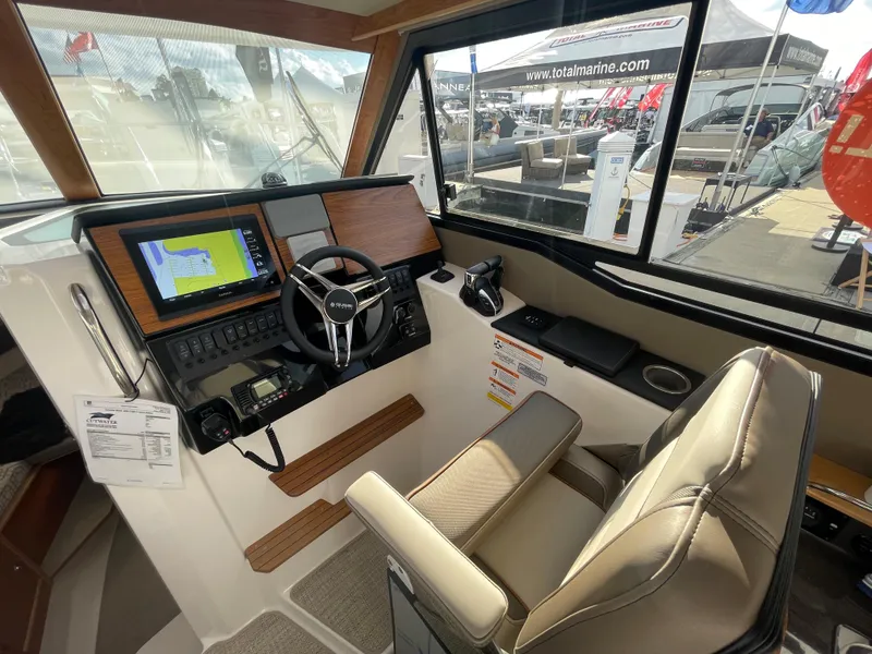 Slide: The Image of 2023 Cutwater C-288 helm station with navigation screens and comfortable captain's chair. - 28