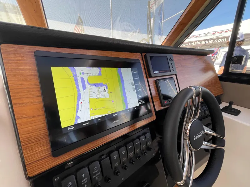 Slide: The Image of 2023 Cutwater C-288 boat dashboard with navigation screen and steering wheel. - 29