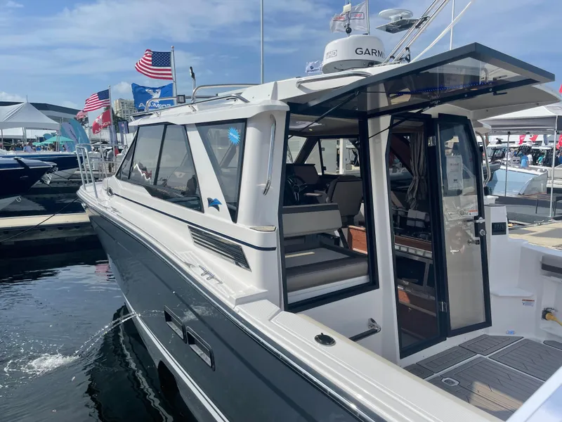 Slide: The Image of 2023 Cutwater C-288 boat docked at a marina, showcasing its sleek design and modern features. - 3