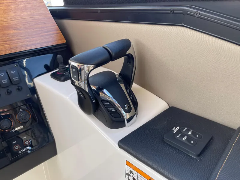 Slide: The Image of 2023 Cutwater C-288 boat control panel with throttle and remote. - 32