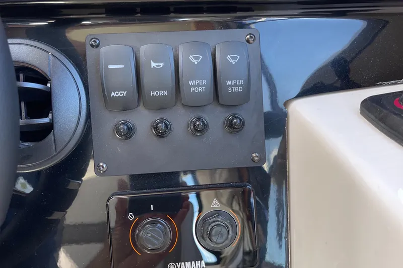 Slide: The Image of Control panel of a 2023 Cutwater C-288 boat with accessory and wiper switches. - 34