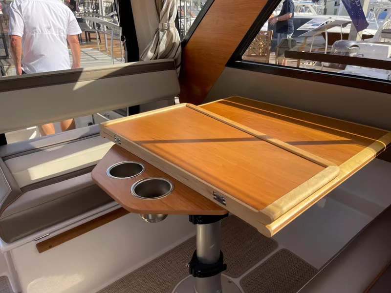 Slide: The Image of 2023 Cutwater C-288 interior with wooden table and cup holders. - 40
