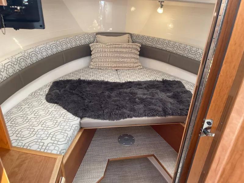 Slide: The Image of 2023 Cutwater C-288 boat cabin with cozy bed, pillows, and soft blanket. - 43