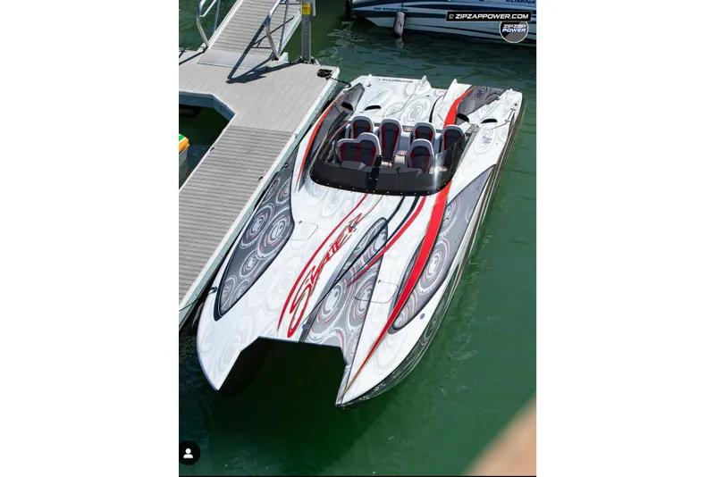 Slide: The Image of 2009 Skater 388 powerboat with sleek design docked on water. - 10