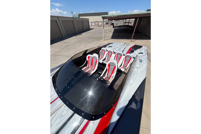 Slide: The Image of 2009 Skater 388 powerboat with sleek design and red-accented seats in a storage area. - 14