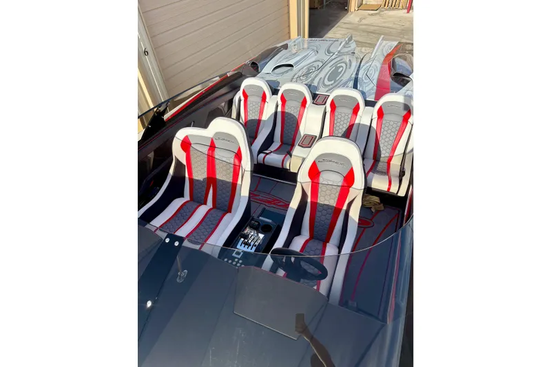 Slide: The Image of 2009 Skater 388 boat interior with red and white seats, sleek design. - 15