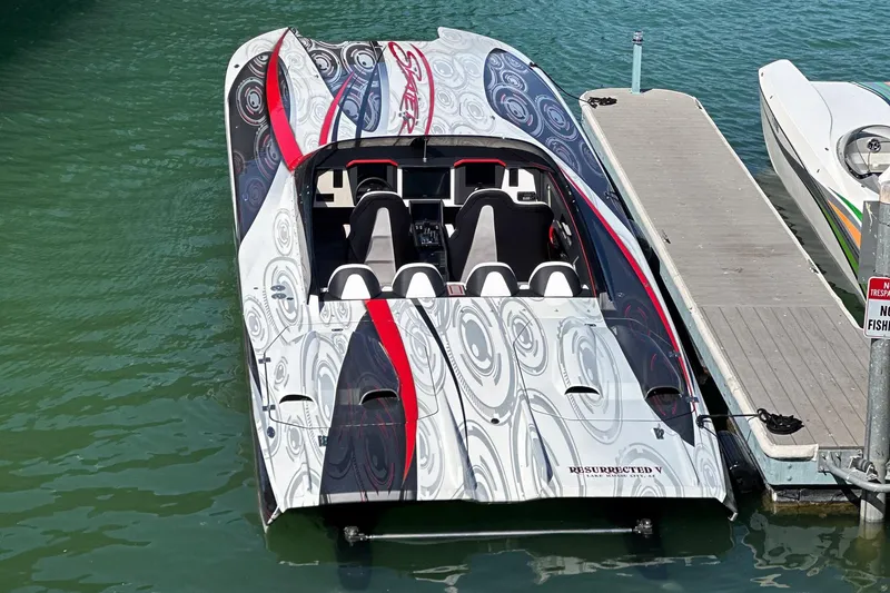Slide: The Image of High-performance 2009 Skater 388 speedboat with striking design docked on calm water. - 4