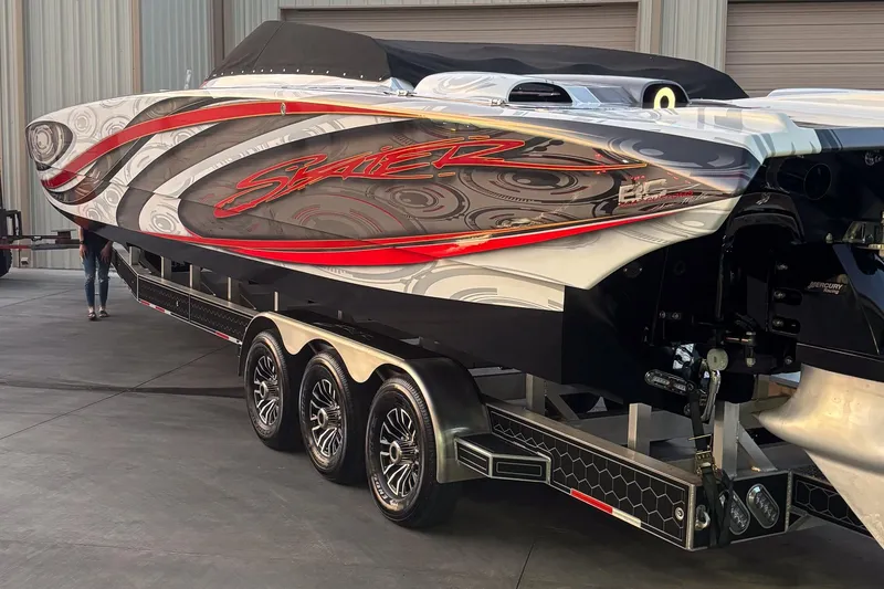 Slide: The Image of 2009 Skater 388 powerboat with vibrant graphics on a multi-axle trailer. - 7