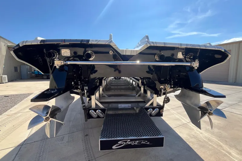 Slide: The Image of Rear view of 2009 Skater 388 boat with dual propellers and sleek black finish. - 8