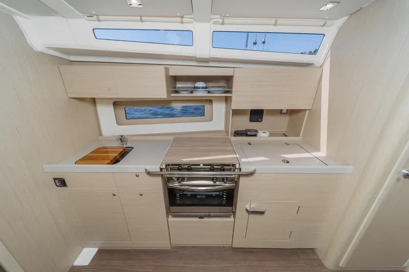 Slide: The Image of Modern kitchen interior of 2025 Beneteau Oceanis 37.1 yacht, featuring sleek cabinetry and appliances. - 11