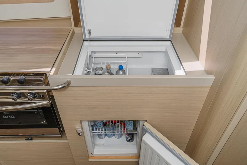 Slide: The Image of Modern kitchen area in 2025 Beneteau Oceanis 37.1 yacht with fridge and stove. - 13