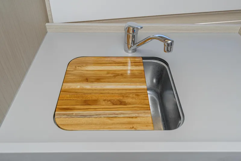 Slide: The Image of Modern kitchen sink with wooden cover in 2025 Beneteau Oceanis 37.1 yacht. - 16
