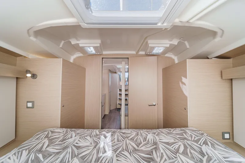 Slide: The Image of Interior of 2025 Beneteau Oceanis 37.1 yacht, featuring modern cabin design and skylight. - 19