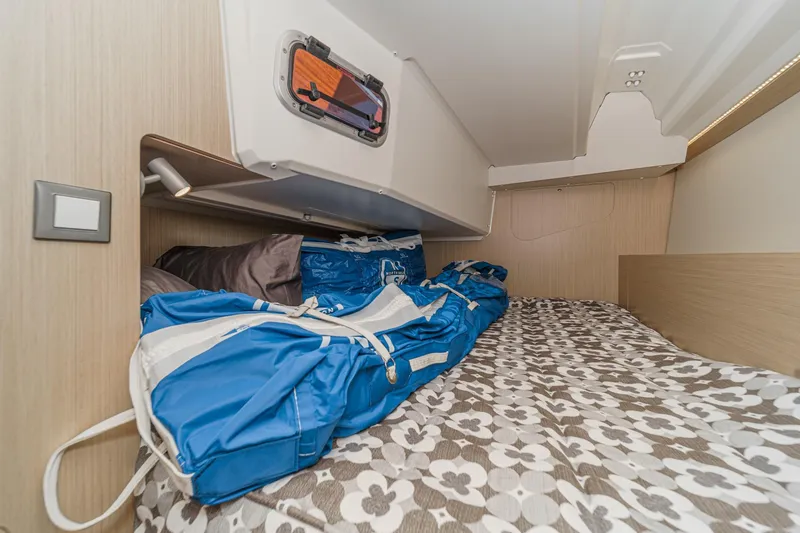 Slide: The Image of Cozy cabin interior of 2025 Beneteau Oceanis 37.1 with floral bedding and storage. - 20