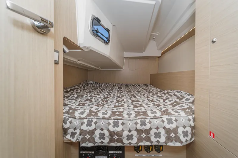Slide: The Image of Cozy cabin interior of 2025 Beneteau Oceanis 37.1 with floral-patterned bedding. - 21