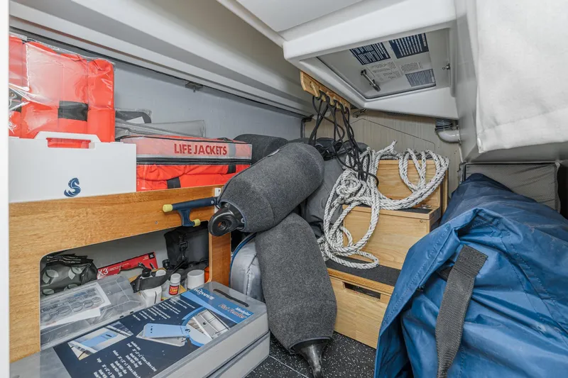 Slide: The Image of Storage area of 2025 Beneteau Oceanis 37.1 with life jackets, ropes, and equipment. - 25