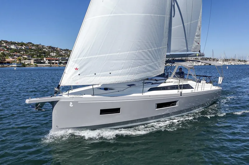 Slide: The Image of 2025 Beneteau Oceanis 37.1 sailing yacht on calm waters under clear blue sky. - 29