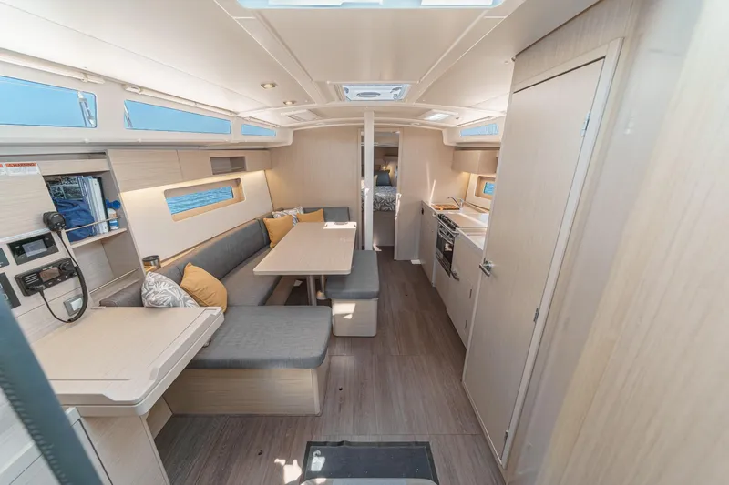 Slide: The Image of Interior of 2025 Beneteau Oceanis 37.1 yacht, featuring modern seating and kitchen area. - 3