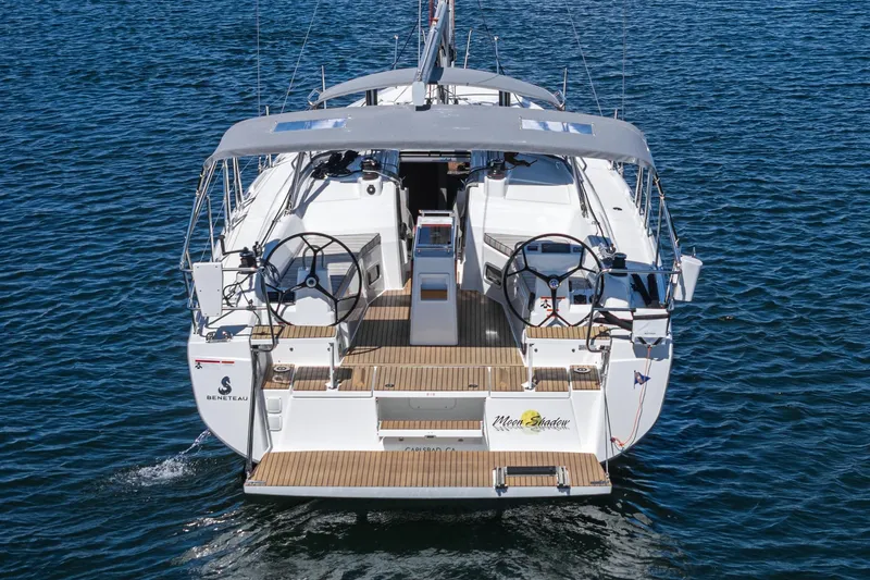 Slide: The Image of 2025 Beneteau Oceanis 37.1 yacht on water, rear view, dual steering wheels. - 38